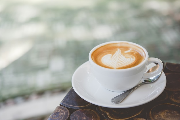 tasse de café latte art sur la table en bois.