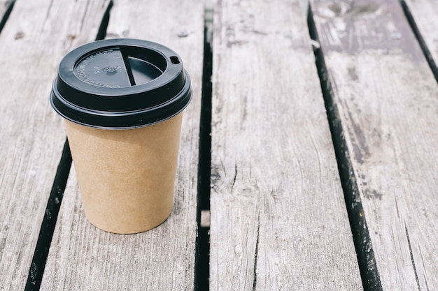 Tasse à café en papier sur bois foncé