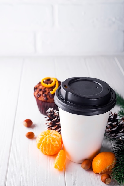 Tasse de café en papier entourée de décorations de Noël