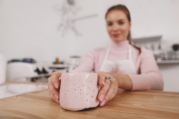 Tasse de café ou de thé entre les mains d'une femme barista