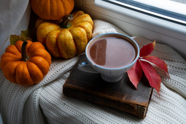 Tasse de chocolat d'automne à côté de citrouilles