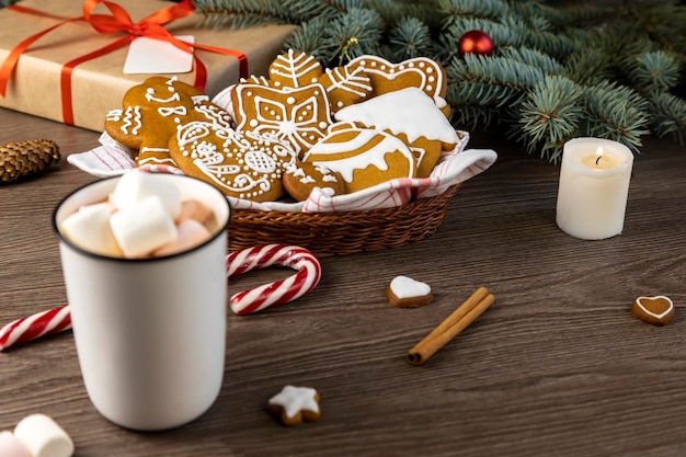 Une tasse de chocolat chaud avec des guimauves et des biscuits au pain d'épice sur une table en bois Décor de Noël Se concentrer sur le pain d'épice