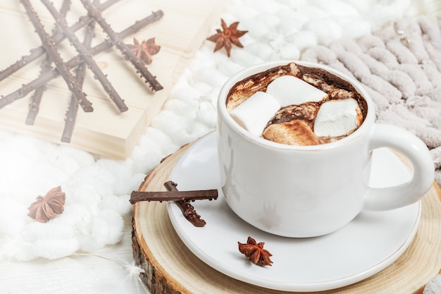 Tasse de chocolat chaud avec des guimauves et des bonbons à la lumière du soleil. Boisson sucrée. Espace de copie.