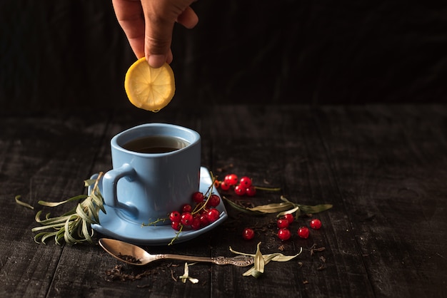 Une tasse de thé au citron sur fond noir