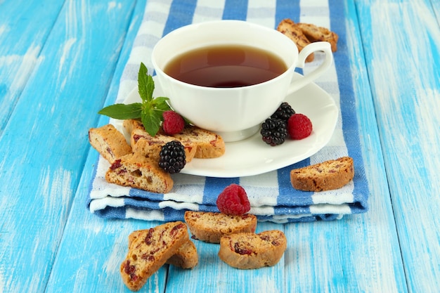 Tasse de thé avec des biscuits et des baies sur la table libre