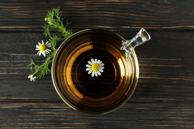 Tasse de thé à la camomille sur table en bois rustique