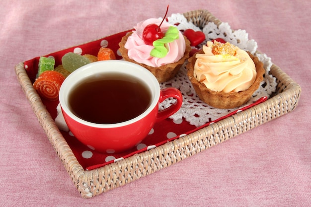 Tasse de thé avec des gâteaux sur un plateau en bois sur la table