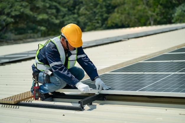 Techniciens portant des modules solaires photovoltaïques sur le toit de la maison Bâtisseurs en casque