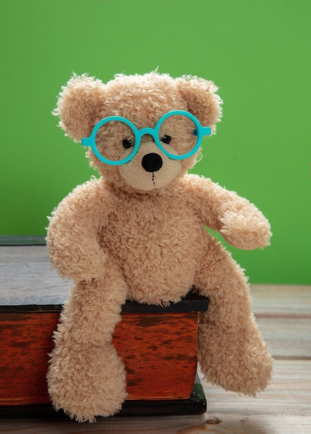 Teddy mignon portant des lunettes sur fond de couleur verte