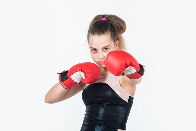 Teen girl boxer training in boxing gloves punching