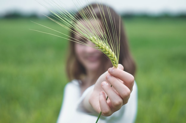 Photo teen girl touche les mains avec des plantes vertes dans le jardin