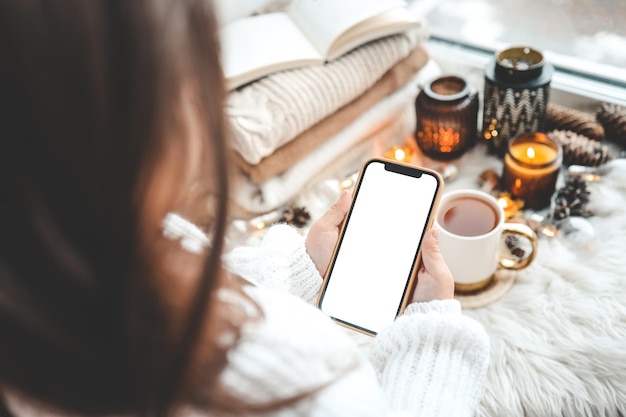 Téléphone en mains avec place isolée pour le texte dans l'ambiance de Noël