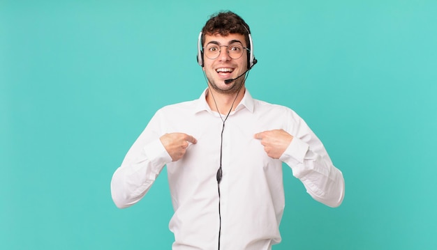 Télévendeur se sentant heureux, surpris et fier, se montrant lui-même avec un regard excité et étonné