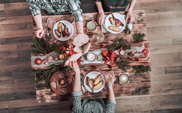 Télévision à plat d'amis mains manger et boire ensemble. Vue de dessus des personnes ayant fête, rassemblement, célébration ensemble à table rustique en bois