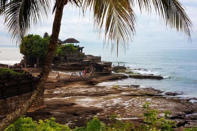 Temple hindou de Tanah lot vu d'un palmier sur l'île de Bali Indonésie