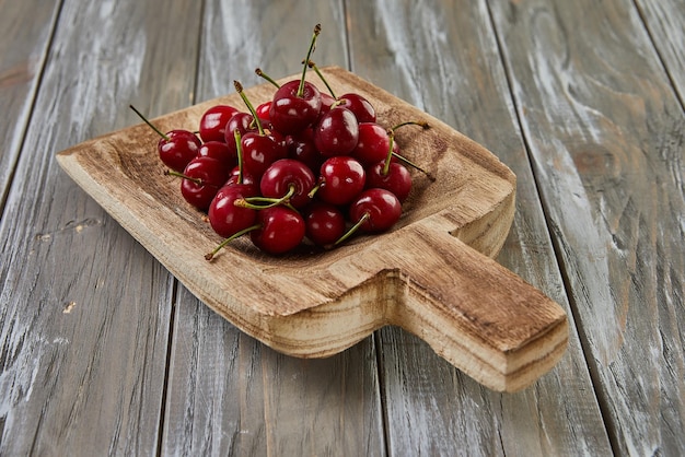 Tempting Harvest Juicy Cherrys Overflow on Wooden Scoop Nature's Sweet Bounty