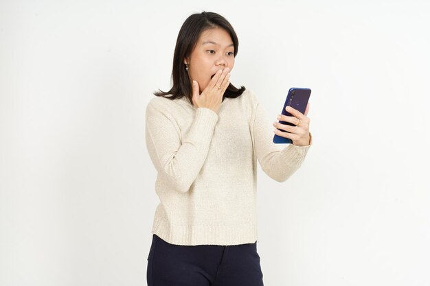 Tenir et utiliser le smartphone de la belle femme asiatique isolée sur fond blanc