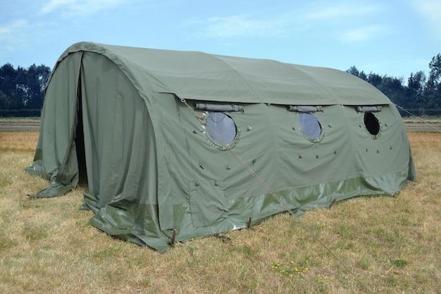 Photo tente militaire verte avec fenêtres debout sur le terrain