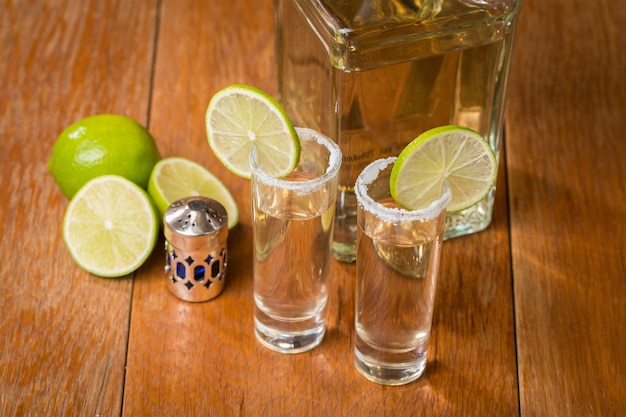 Tequila dans des verres à liqueur avec de la chaux et du sel