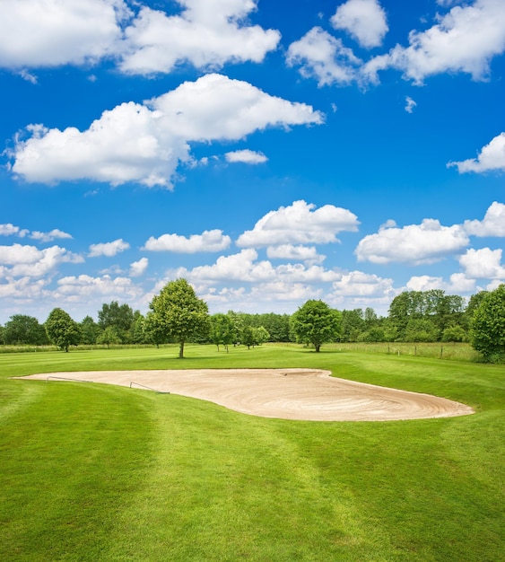 Terrain de golf vert et ciel nuageux bleu