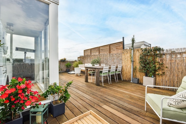 Une terrasse avec une table et des chaises dessus