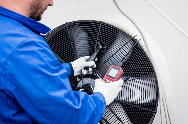 Test avec un anémomètre d'un ventilateur axial du groupe de condensation