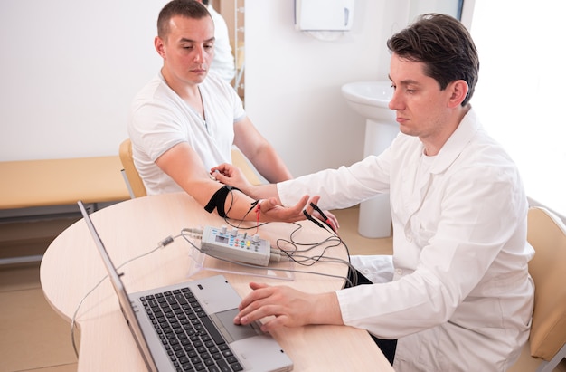 Test des nerfs du patient à l'aide de l'électromyographie au centre médical