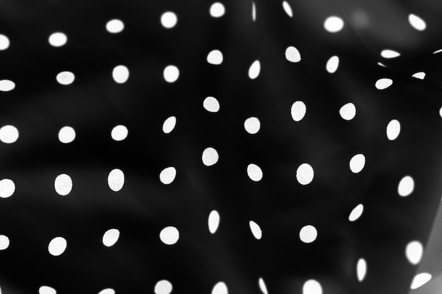 Texture d'arrière-plan textile à pois vintage points blancs sur le modèle de conception de tissu de luxe noir