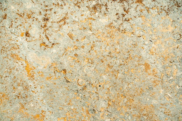 Texture de béton vieilli. vieux fond d'or vintage. orange avec rugosité et craquelures.