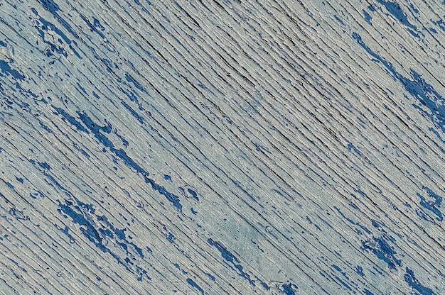 Texture en bois patiné avec des rayures bleues craquelées en diagonale avec de la peinture écaillée à sec.