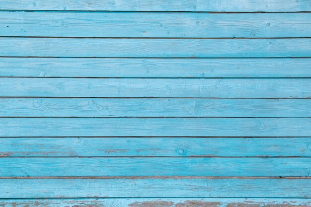 Texture en bois avec de la vieille peinture bleue fissurée