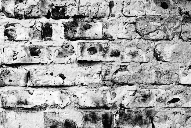 Texture, brique, fond de mur. Texture de brique avec rayures et fissures