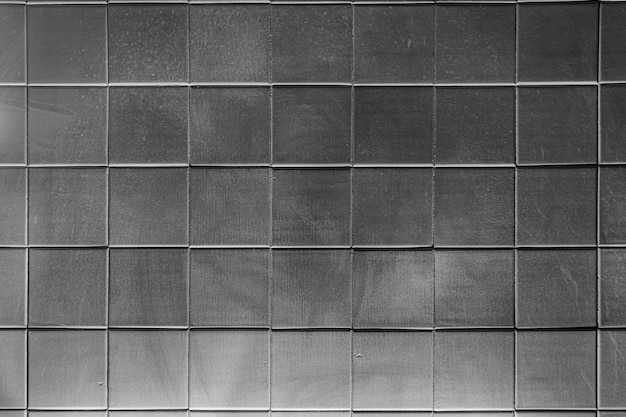 La texture des carreaux de céramique carrés brillants et inégaux Éclairage sombre et dur en bas