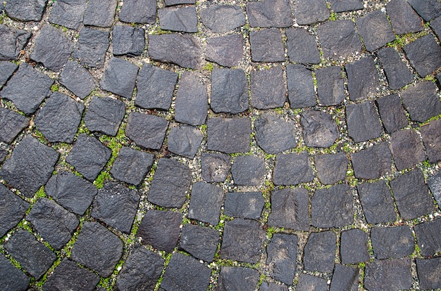 Texture de la chaussée en pierre. Fond pavé de granit. Résumé du vieux gros plan pavé. Sans couture . Prague