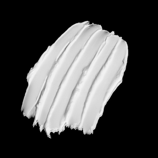 Texture de la crème blanche sur fond noir