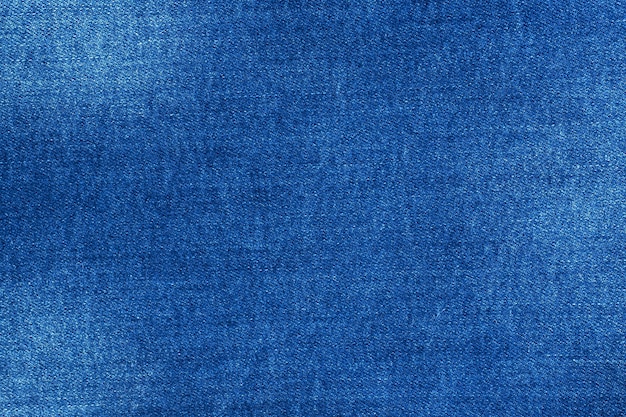 Texture denim bleu avec des éraflures, matériel de table de jeans.