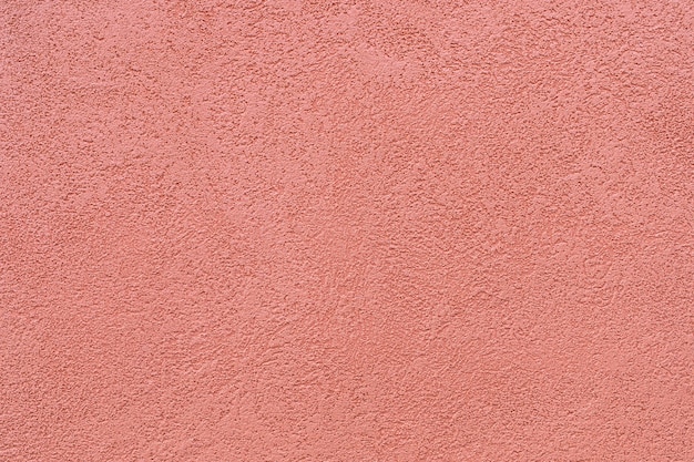 La texture du plâtre sur les murs extérieurs des maisons est peinte en couleur ocre