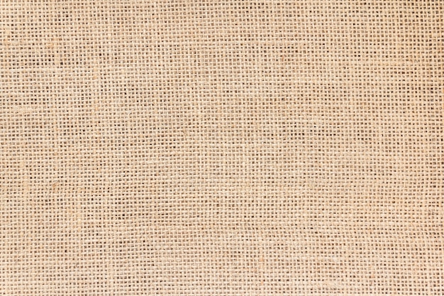 La texture du sac en toile de jute brune peut être utilisée comme arrière-plan