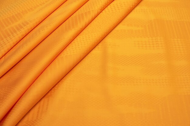 La texture du tissu en coton est orange.