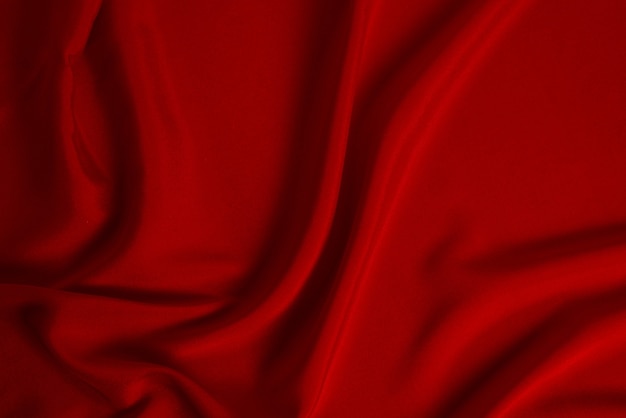 La texture du tissu de luxe en soie rouge ou en satin peut être utilisée comme arrière-plan abstrait. Vue de dessus