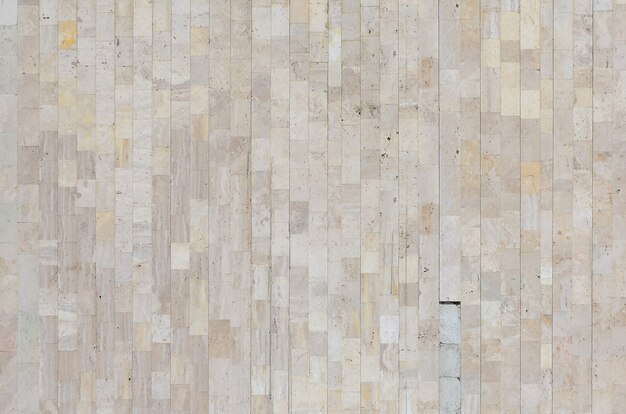 texture du vieux mur de marbre beige fait d'une variété de grandes tuiles