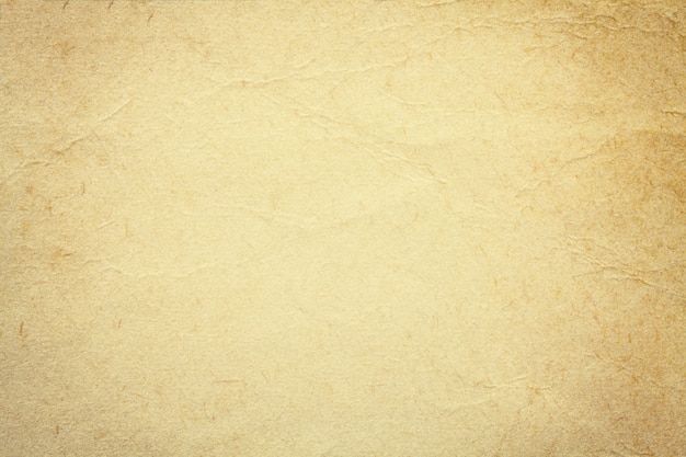 Photo texture du vieux papier beige, fond froissé. toile de fond grunge sable vintage.