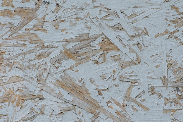 Texture de feuille OSB en contreplaqué blanc peint faite de copeaux de bois Gros plan