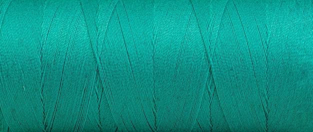 Texture des fils dans une bobine de couleur verte sur fond blanc