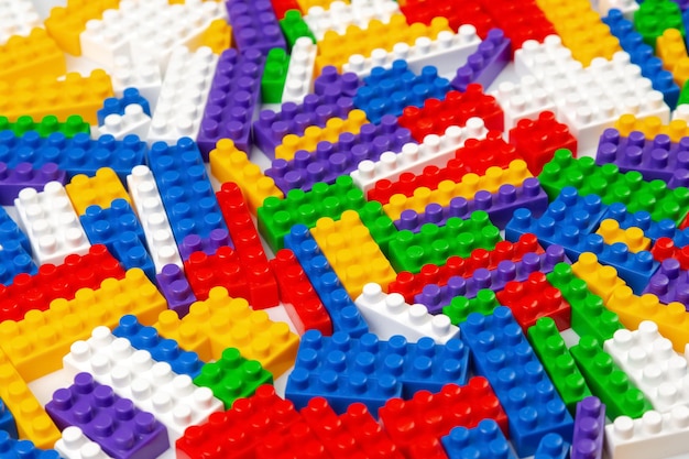 Texture de fond abstraite des blocs de construction colorés Arrière-plan de la partie en plastique colorée du constructeur Tas de briques de jouet colorées
