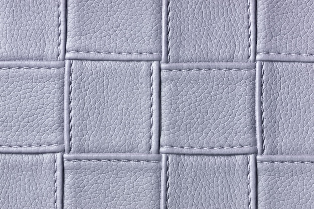 Texture de fond en cuir gris avec motif carré et point, macro. Textile de forme géométrique.