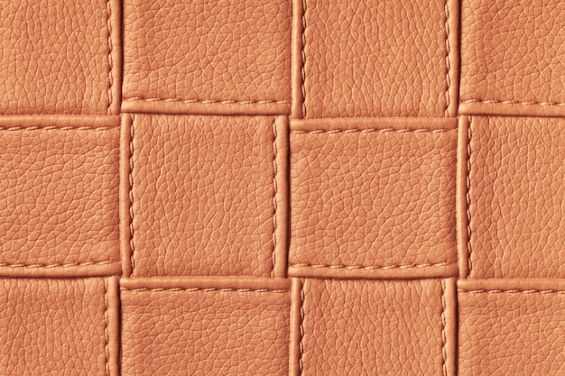 Texture de fond en cuir orange et rouge foncé avec motif carré et point