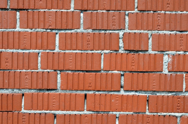 texture de fond de mur de brique rouge ondulé