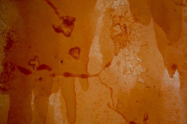 Texture de fond de mur de pierre vintage grunge avec texture orange de mur de grunge de peinture de tache de cosse