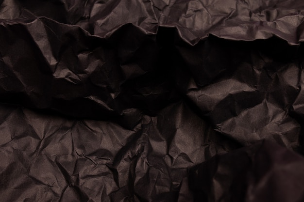 Texture ou fond de papier froissé aux tons noirs détaillés